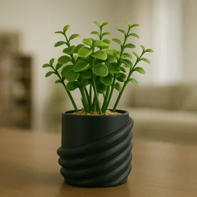 My Store 2 artificial succulent with green leaves in a modern matte black spiral-ribbed ceramic pot on a table.
